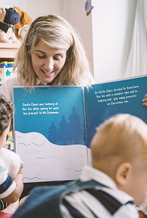 Licensed Virginia educator reading to preschool children at Falls Church daycare